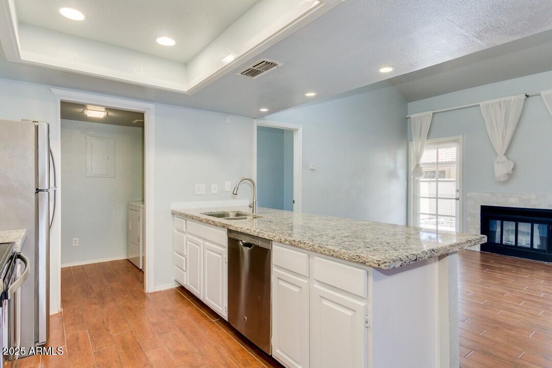 6900 East Gold Dust Avenue, Unit 149 Paradise Valley, AZ 85253 - Photo 17 of 34 a kitchen with a sink stove and cabinets