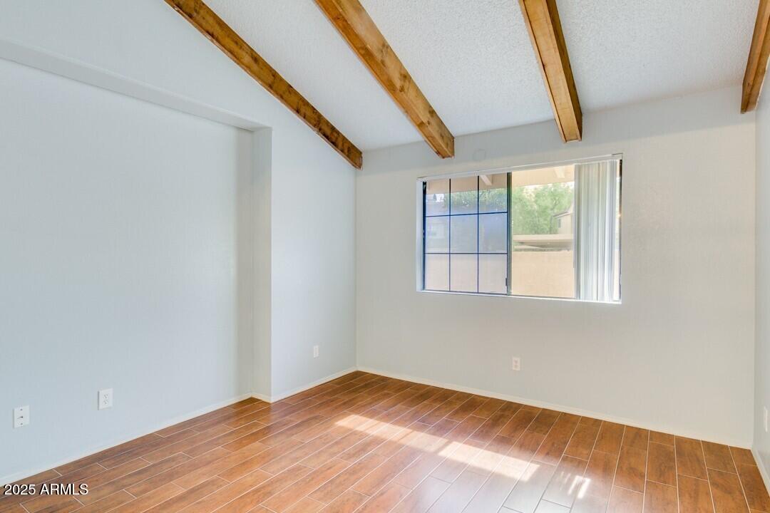 6900 East Gold Dust Avenue, Unit 149 Paradise Valley, AZ 85253 - Photo 20 of 34 a view of empty room with wooden floor and fan
