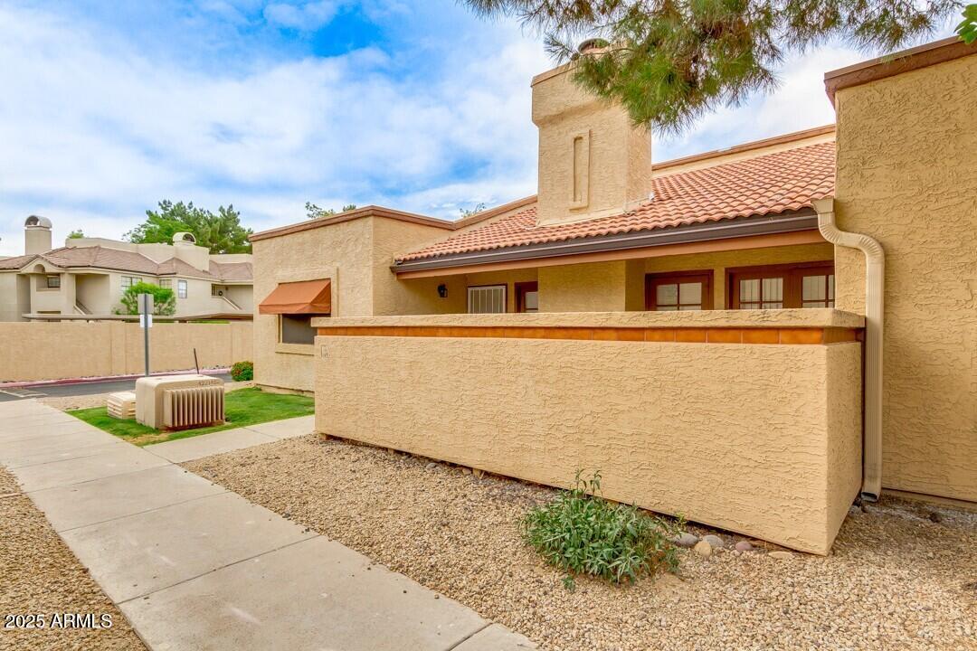 6900 East Gold Dust Avenue, Unit 149 Paradise Valley, AZ 85253 - Photo 2 of 34 a front view of a house with garden