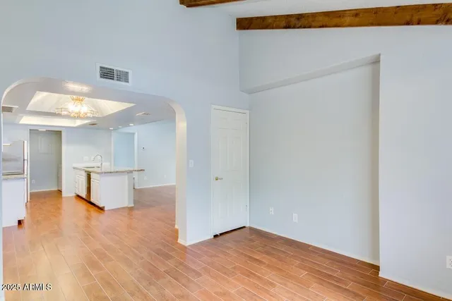 an empty room with windows and closet