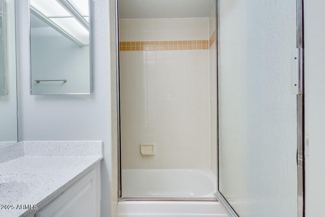 6900 East Gold Dust Avenue, Unit 149 Paradise Valley, AZ 85253 - Photo 30 of 34 a bathroom with a granite countertop sink and a bathtub