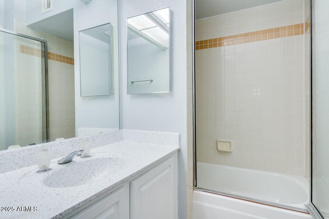 6900 East Gold Dust Avenue, Unit 149 Paradise Valley, AZ 85253 - Photo 31 of 34 a bathroom with a granite countertop sink and a mirror