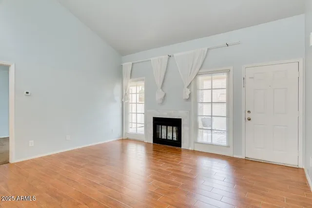 a large kitchen with a lot of counter space and a wooden floor