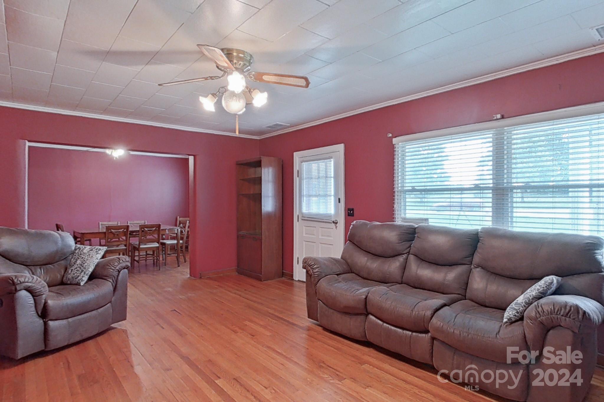 700 South Myrtle School Road Gastonia, NC 28052 - Photo 11 of 40 a living room with furniture a chandelier and a window