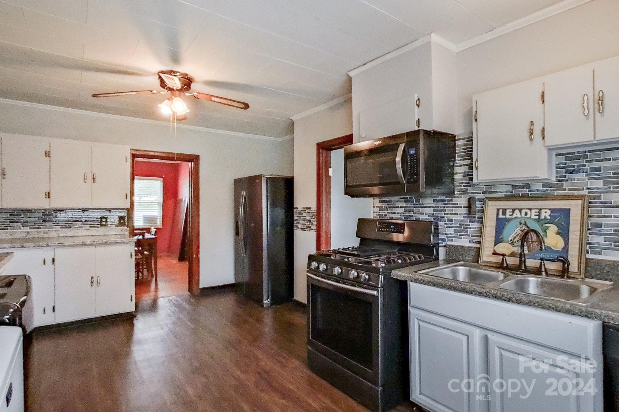 700 South Myrtle School Road Gastonia, NC 28052 - Photo 15 of 40 a kitchen with stainless steel appliances granite countertop a stove sink and microwave