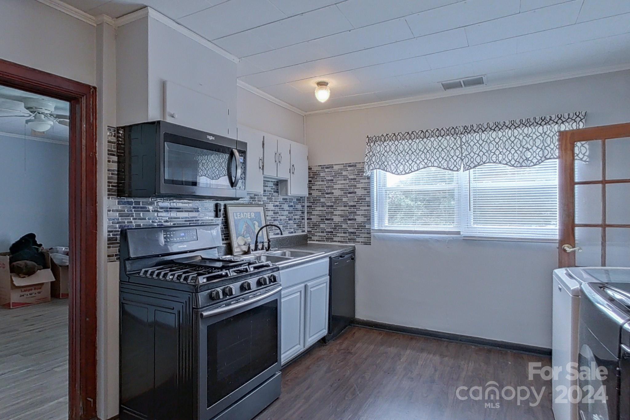 700 South Myrtle School Road Gastonia, NC 28052 - Photo 17 of 40 a kitchen with a stove a microwave and window