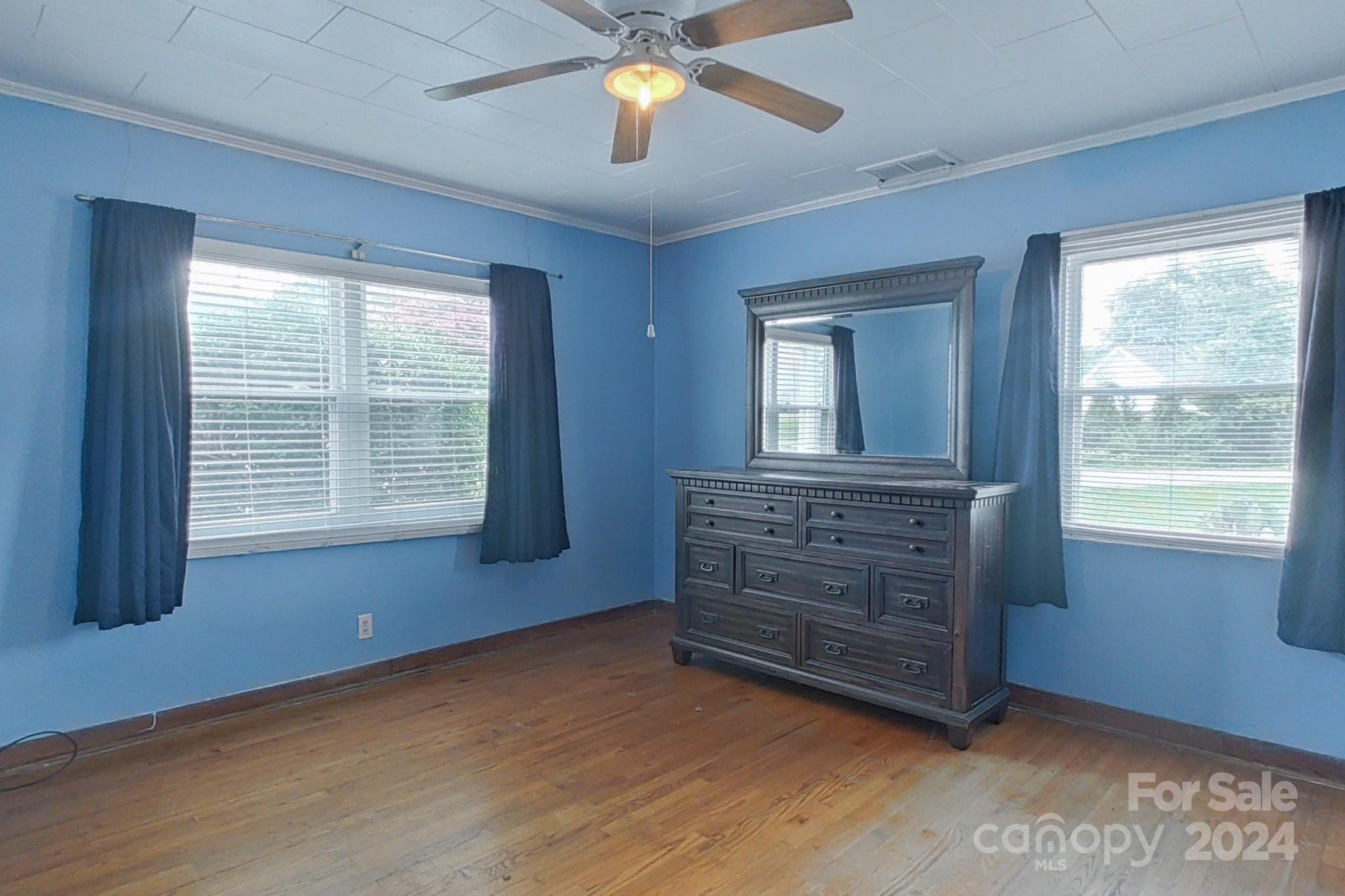 700 South Myrtle School Road Gastonia, NC 28052 - Photo 22 of 40 an empty room with windows closet and chandelier fan