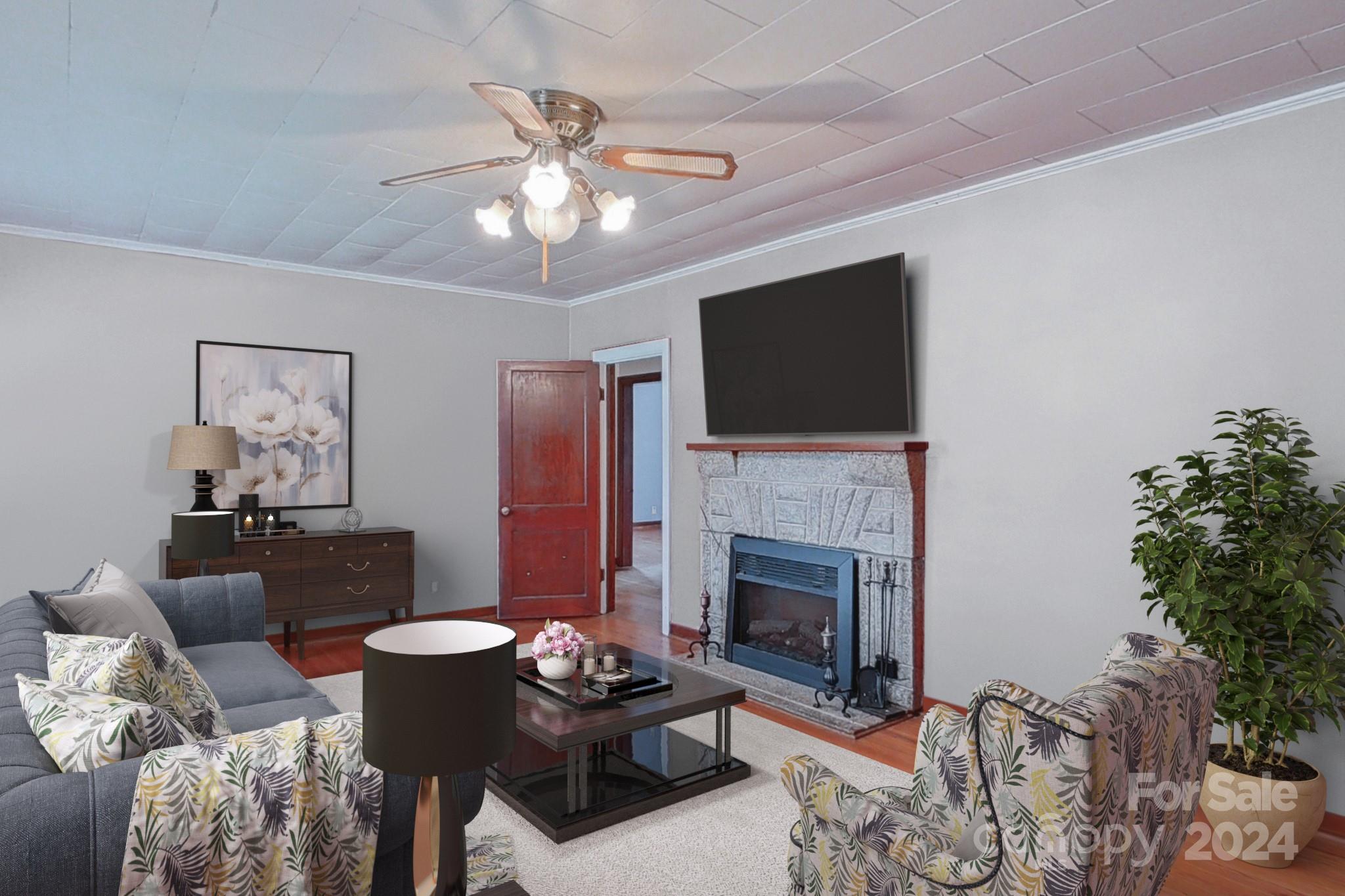 700 South Myrtle School Road Gastonia, NC 28052 - Photo 3 of 40 a living room with furniture a fireplace and a flat screen tv