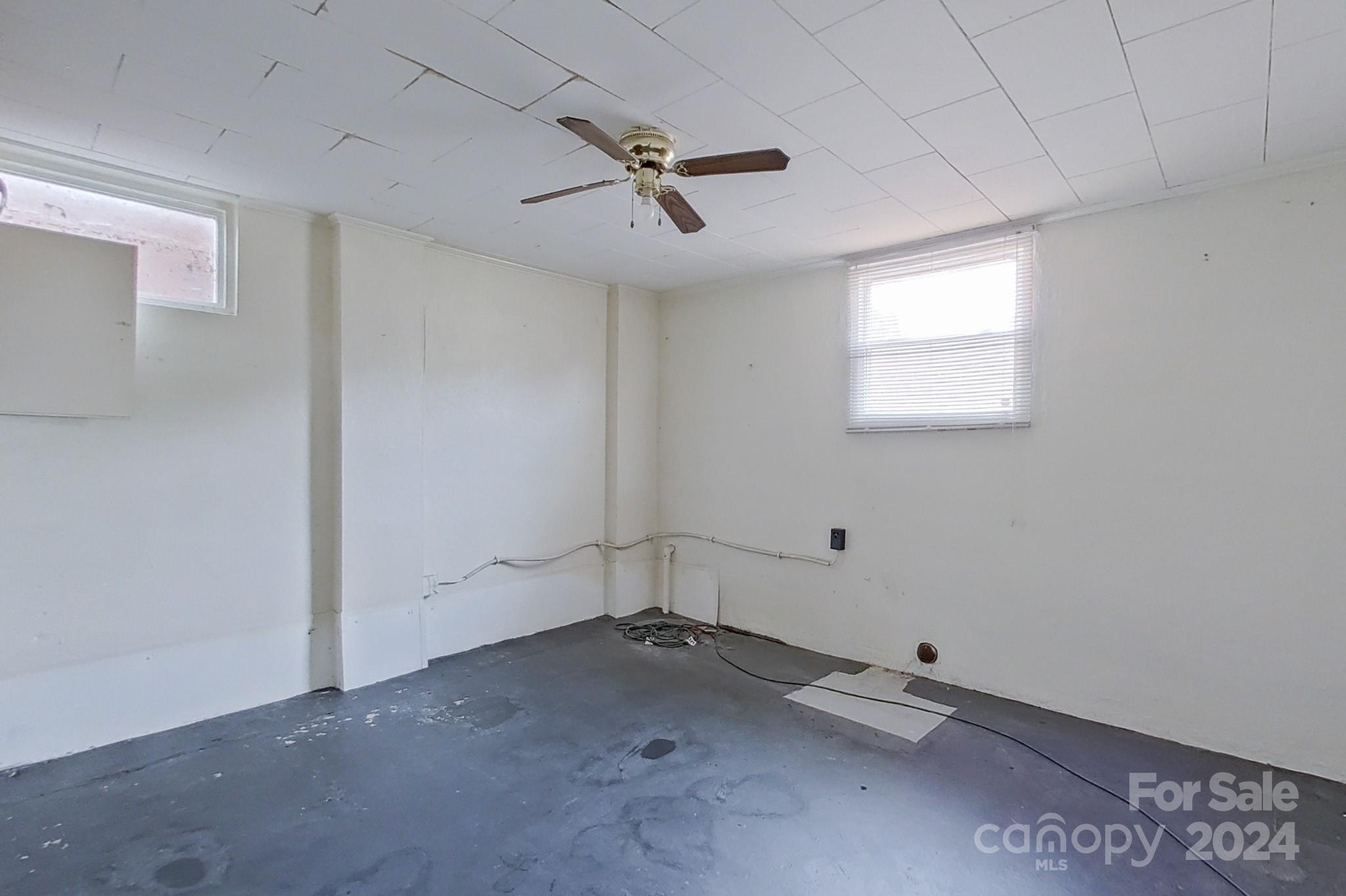 700 South Myrtle School Road Gastonia, NC 28052 - Photo 34 of 40 an empty room with a ceiling fan and window