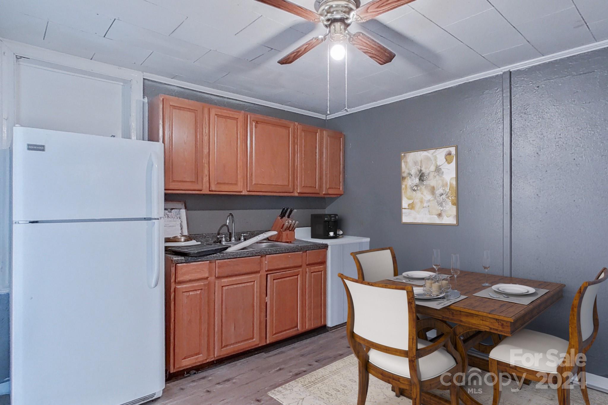 700 South Myrtle School Road Gastonia, NC 28052 - Photo 8 of 40 a kitchen with a dining table chairs cabinets and stainless steel appliances