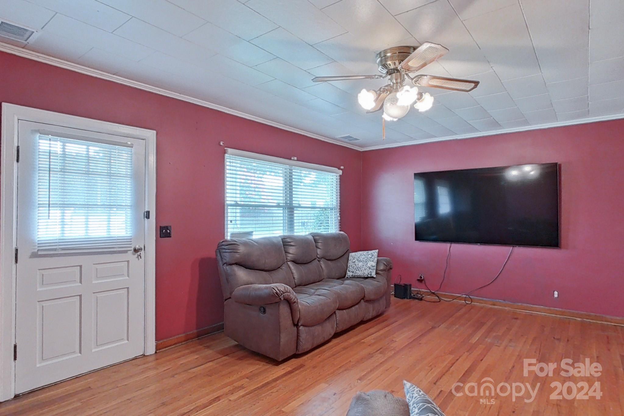 700 South Myrtle School Road Gastonia, NC 28052 - Photo 9 of 40 a living room with furniture and a flat screen tv