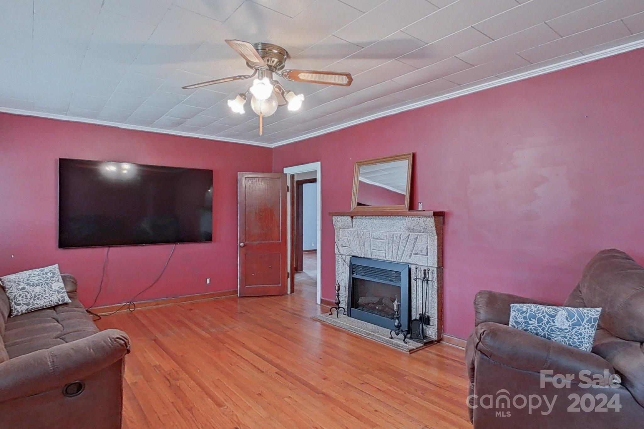 700 South Myrtle School Road Gastonia, NC 28052 - Photo 10 of 40 a living room with furniture and a flat screen tv