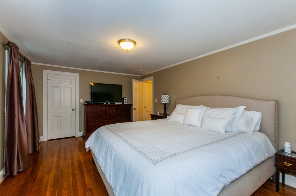 327 Edgell Road Framingham, MA 01701 - Photo 11 of 13 a bedroom with a bed and a flat screen tv