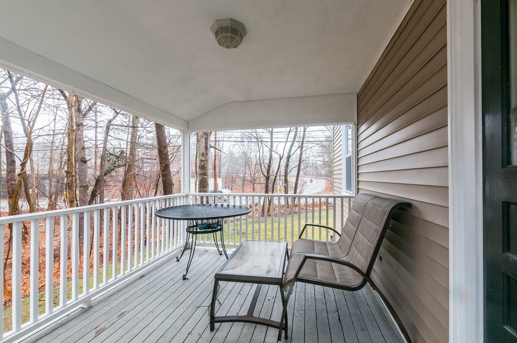 327 Edgell Road Framingham, MA 01701 - Photo 4 of 13 a view of a balcony with furniture and wooden floor