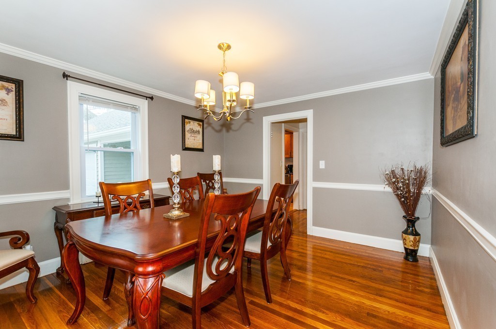327 Edgell Road Framingham, MA 01701 - Photo 5 of 13 a dining room with furniture a chandelier and wooden floor