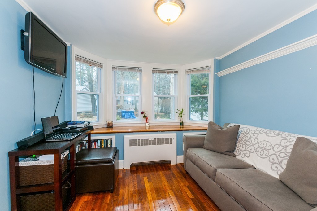 327 Edgell Road Framingham, MA 01701 - Photo 8 of 13 a living room with furniture and a flat screen tv