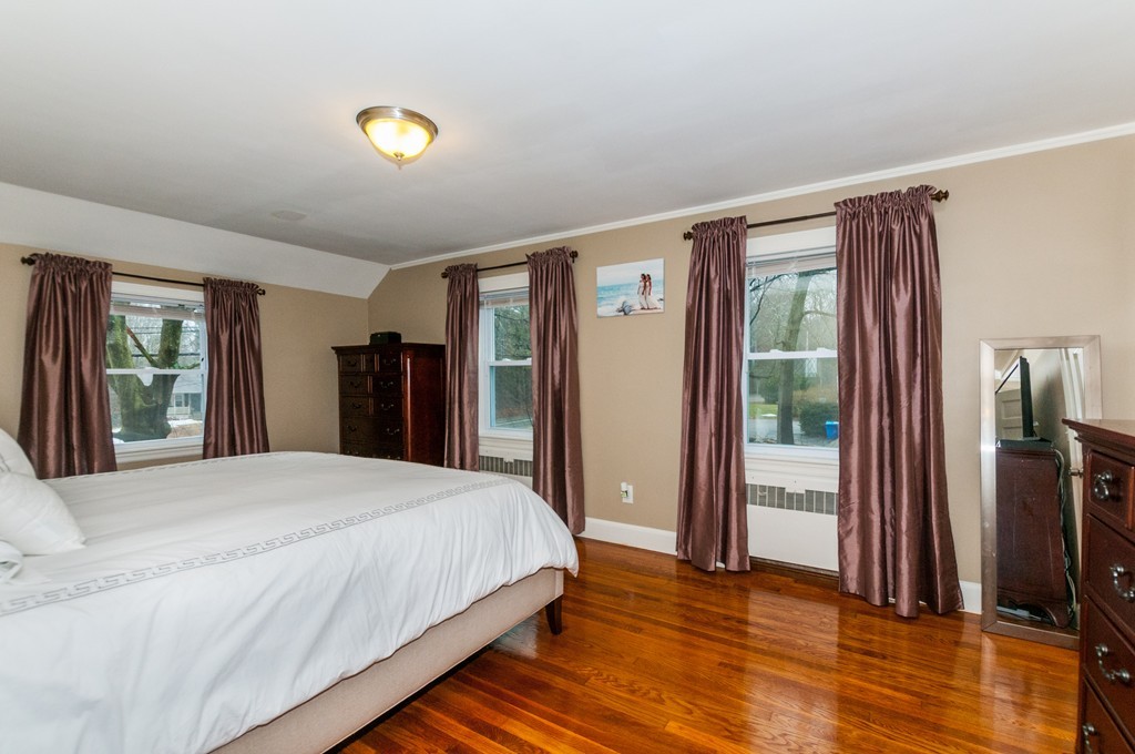 327 Edgell Road Framingham, MA 01701 - Photo 10 of 13 a bedroom with a bed and a dresser next to a window