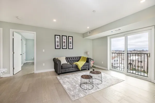 a living room with furniture and a large window