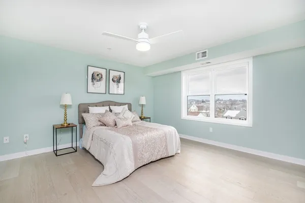 a bedroom with a large bed and a window