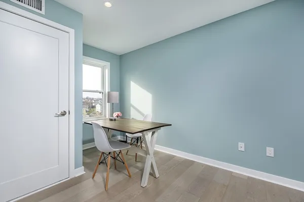 a view of a dining room with a table and chairs