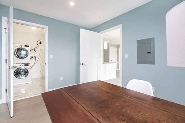 a bedroom with a bed and painting on the wall