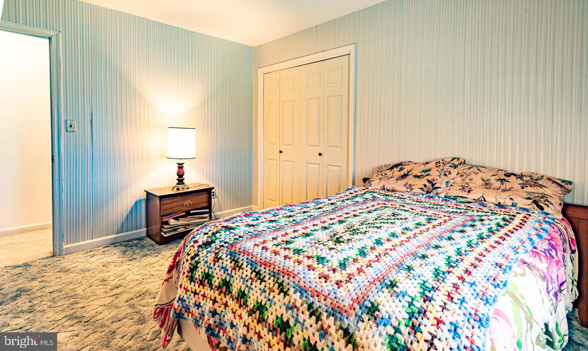 9619 Boyds Turn Road Owings, MD 20736 - Photo 29 of 69 a bedroom with a bed and a lamp on dresser