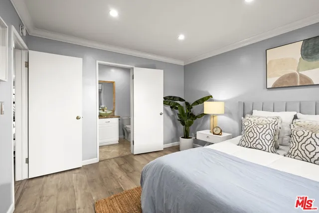 a bedroom with a bed and a painting