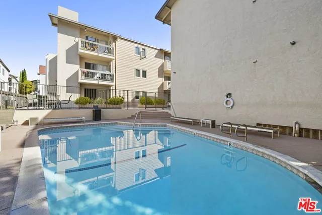 a view of a swimming pool with outdoor seating