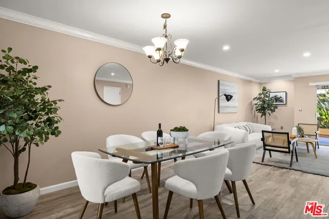a dining room with furniture potted plants and wooden floor