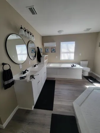 a bathroom with a double vanity sink and mirror