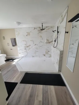 a bathroom with a bathtub and a shower