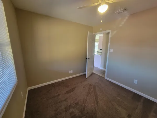 an empty room with an empty space and a bathroom sink