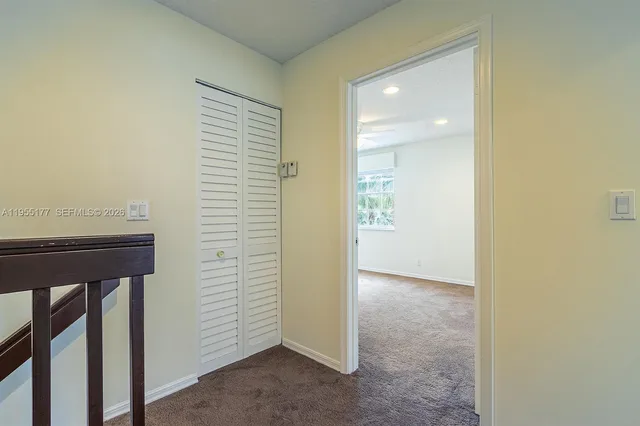 an empty room with fan and entrance