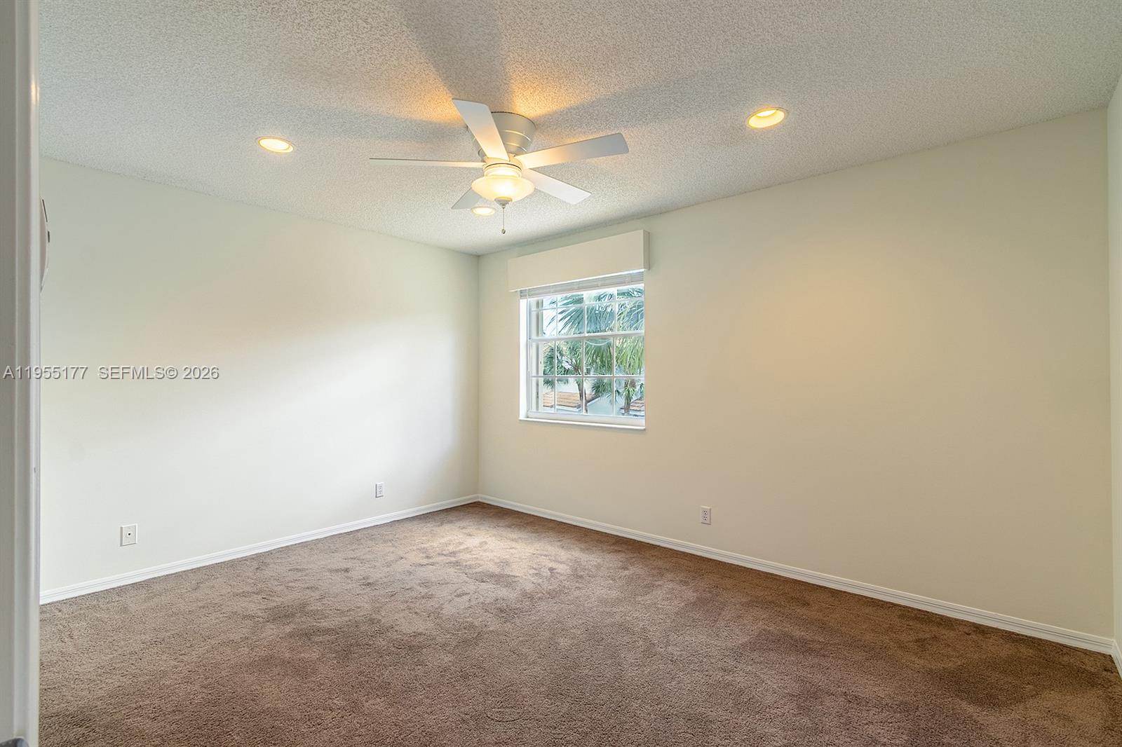 7387 Panache Way Boca Raton, FL 33433 - Photo 26 of 53 an empty room with a window and a fan