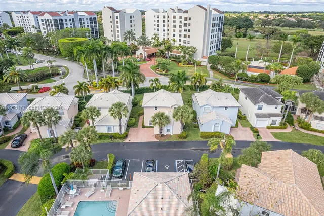 an aerial view of residential houses with outdoor space and river