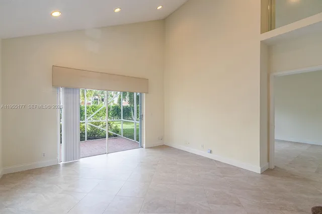 an empty room with wooden floor and sliding door