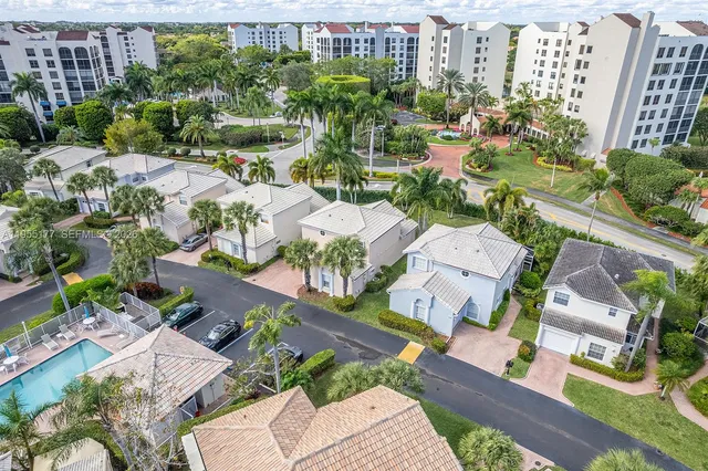 an aerial view of a house with a yard and a fountain