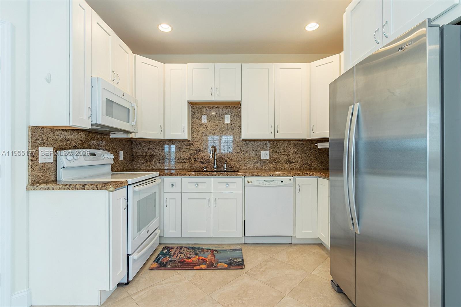 7387 Panache Way Boca Raton, FL 33433 - Photo 8 of 53 a kitchen with stainless steel appliances granite countertop a refrigerator sink and cabinets