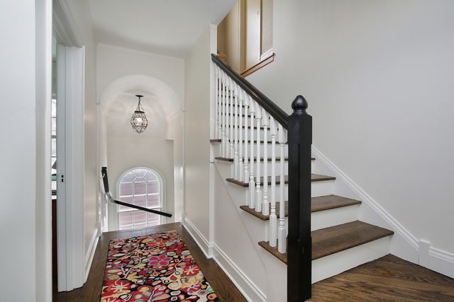 a view of entryway with wooden floor and stairs