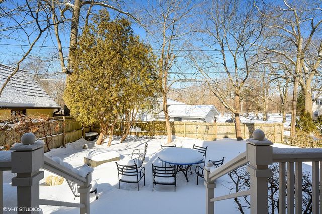 a view of a patio with table and chairs and potted plants
