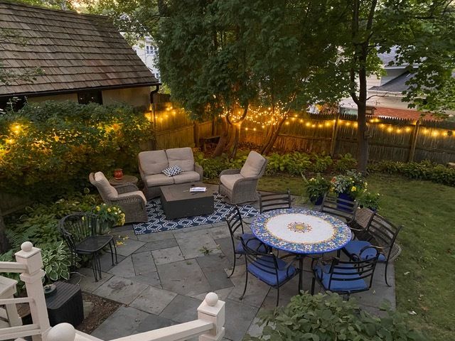 a backyard of a house with table and chairs