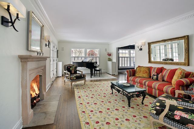 a living room with furniture a fireplace and a window