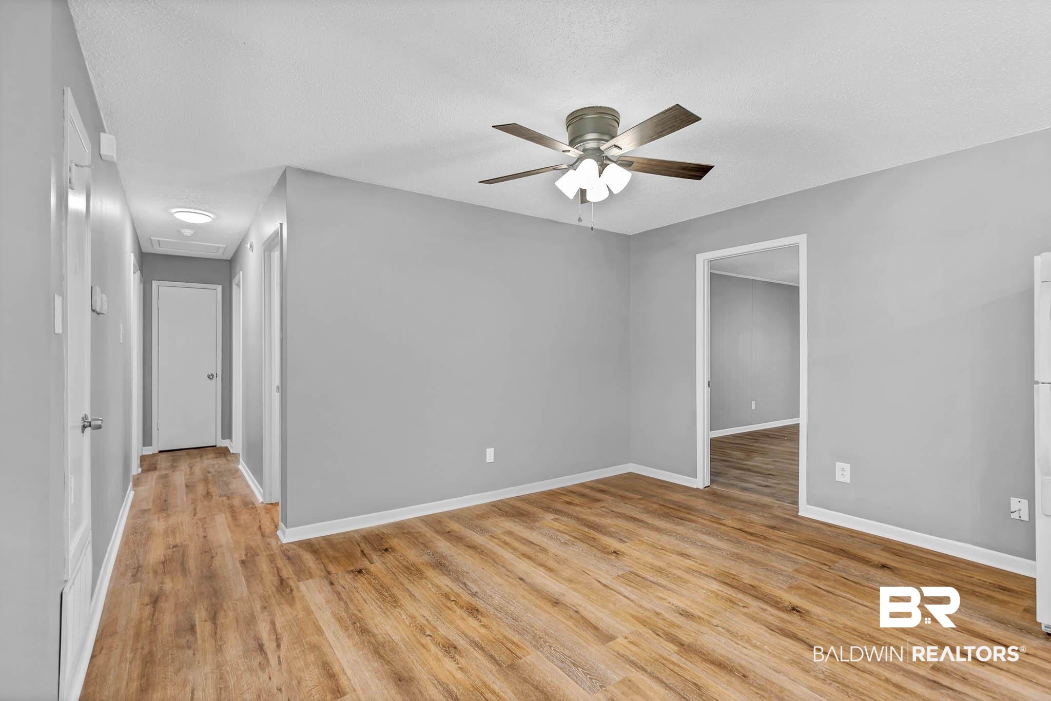 3304 Armond Drive Mobile, AL 36605 - Photo 12 of 62 Empty room featuring ceiling fan, light wood finished floors, and attic access