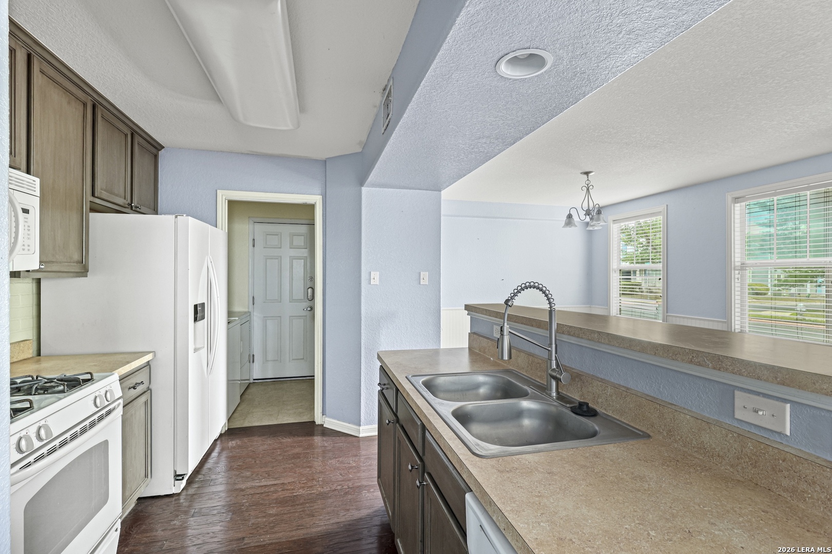 202 Trestle Tree San Marcos, TX 78666 - Photo 10 of 22 a kitchen with a stove sink and refrigerator