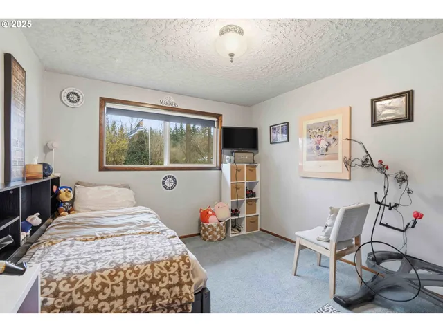 a bedroom with a bed and a large window