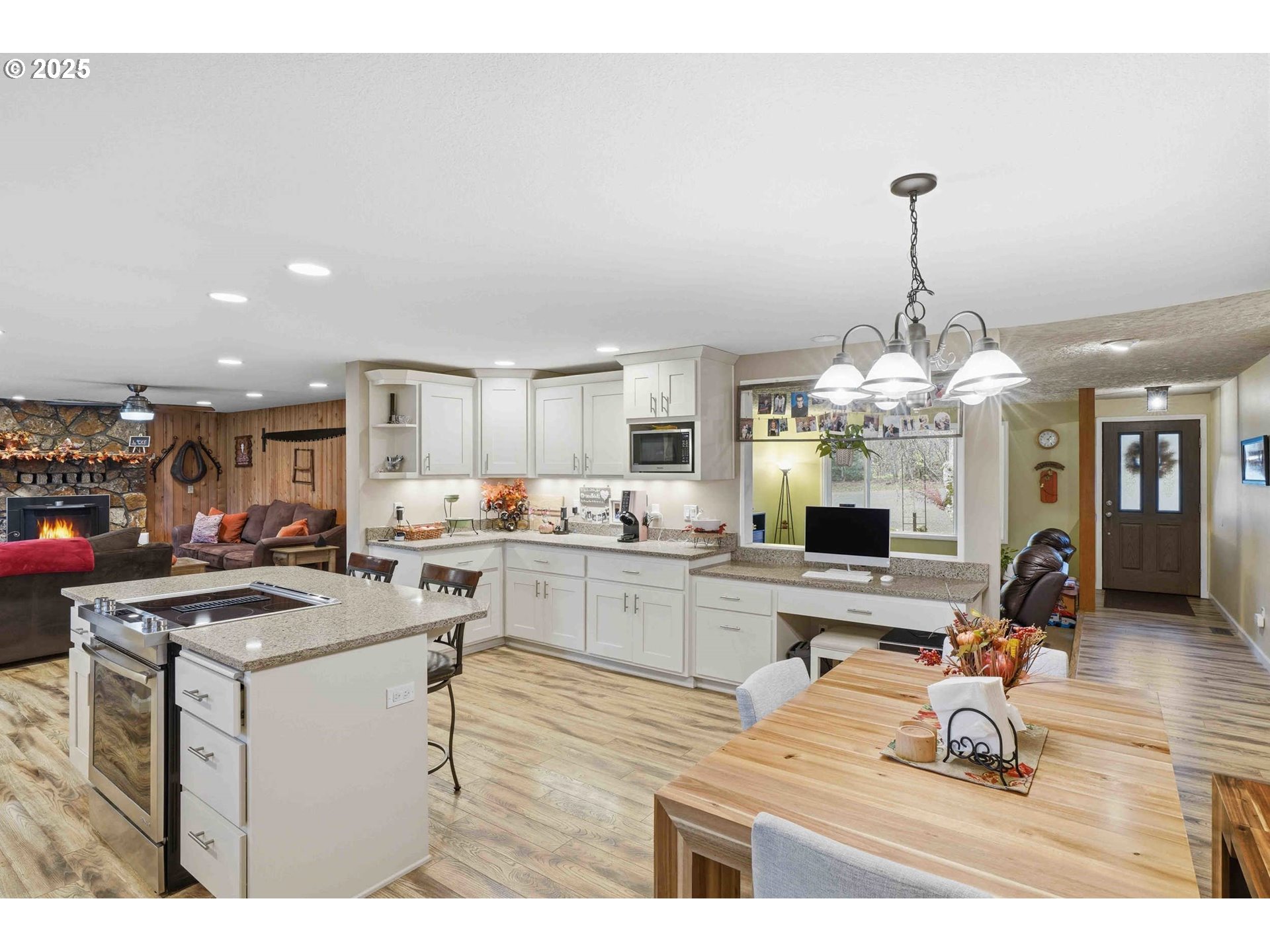 25511 Northeast 13th Street Camas, WA 98607 - Photo 10 of 36 a room with stainless steel appliances kitchen island granite countertop furniture and a chandelier