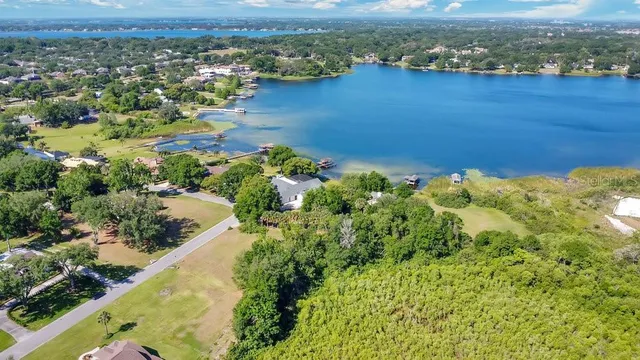 an aerial view of a houses with a lake view