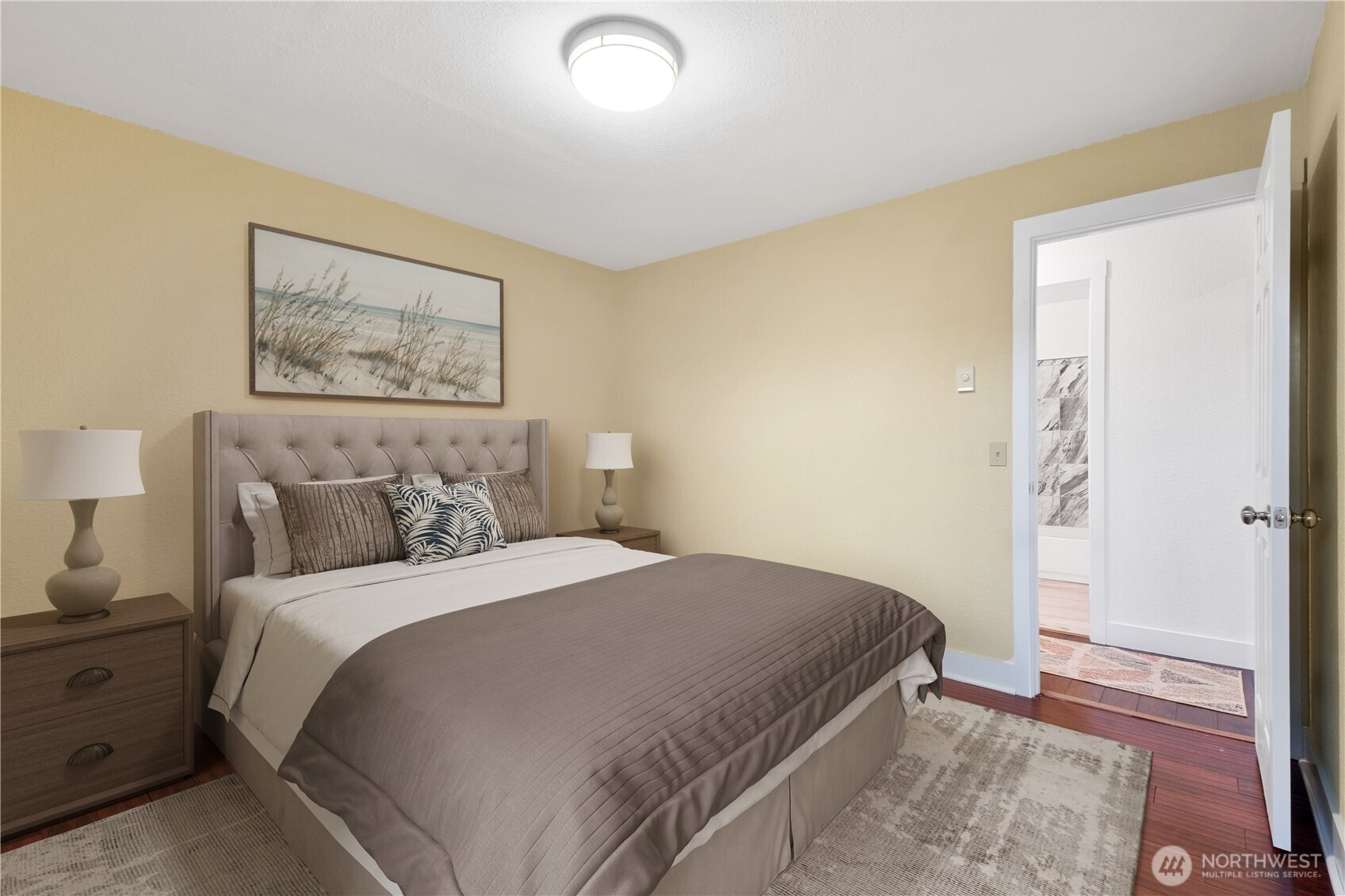 14401 Southeast Petrovitsky Road, Unit B209 Renton, WA 98058 - Photo 20 of 35 a bedroom with a bed and a painting on the wall