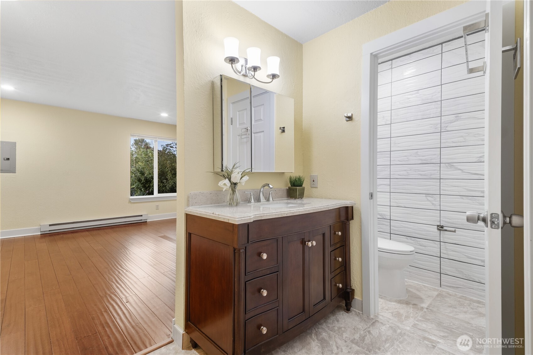 14401 Southeast Petrovitsky Road, Unit B209 Renton, WA 98058 - Photo 25 of 35 a spacious bathroom with a granite countertop sink a toilet and shower