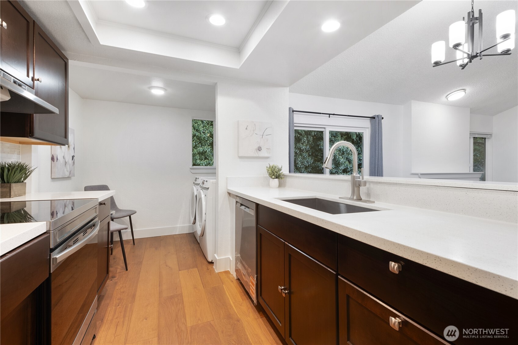 14401 Southeast Petrovitsky Road, Unit B209 Renton, WA 98058 - Photo 6 of 35 a kitchen with a sink appliances and a counter top space